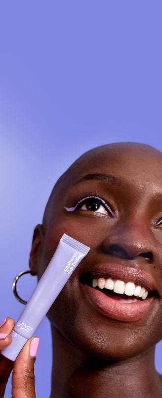 Woman applying skincare product with a blue background